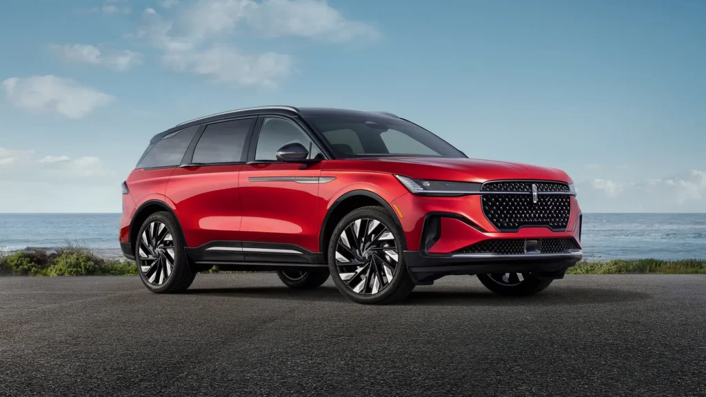 2025 Lincoln Nautilus Reserve in red with ocean backdrop and sporty luxury SUV profile.