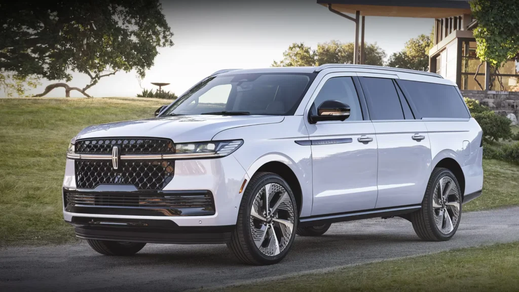 White 2025 Lincoln Navigator Black Label parked on a curved driveway, showcasing chrome wheels and grille.