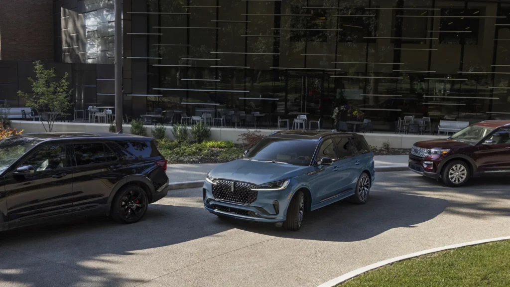 2025 Black Label Aviator in blue parked beside modern building with premium detailing.