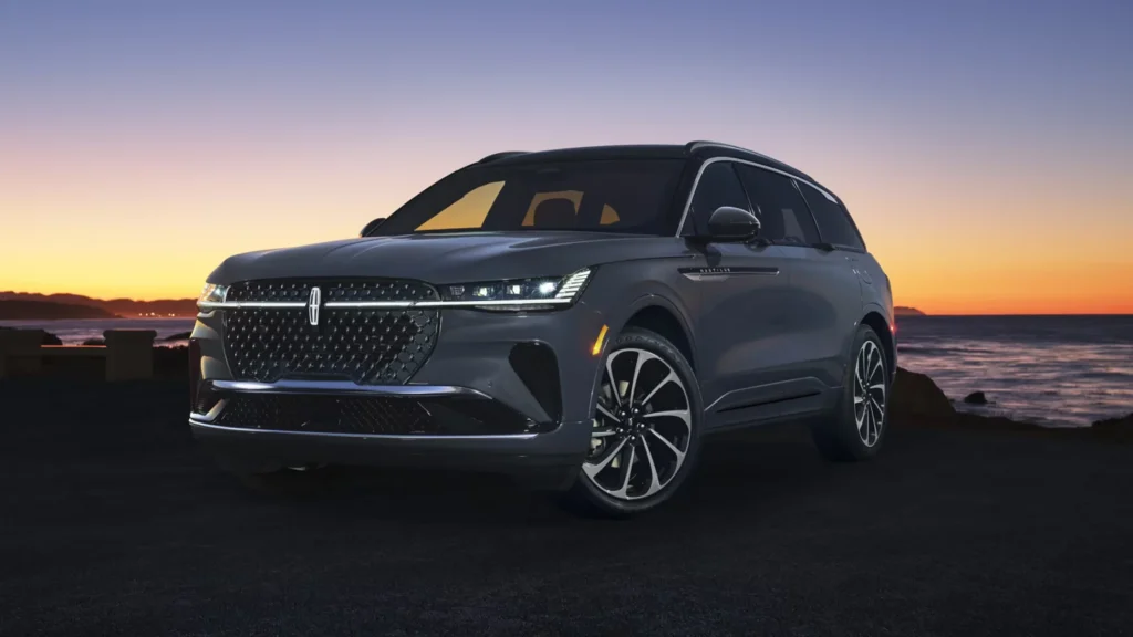 2025 Black Label Nautilus SUV in gray parked at sunset with elegant front grille styling.