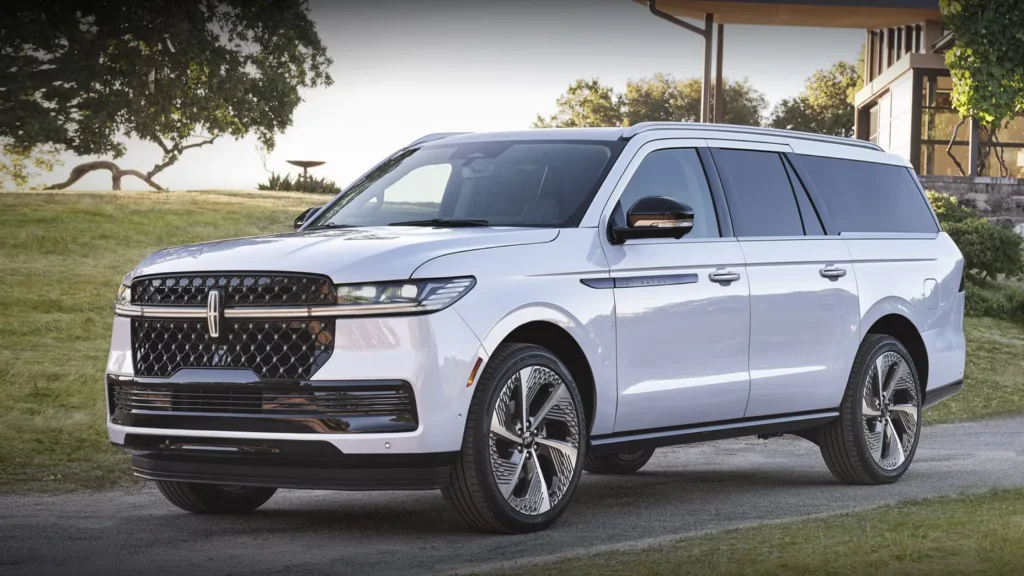 2025 Black Label Navigator in white parked outdoors showcasing luxury chrome grille accents.