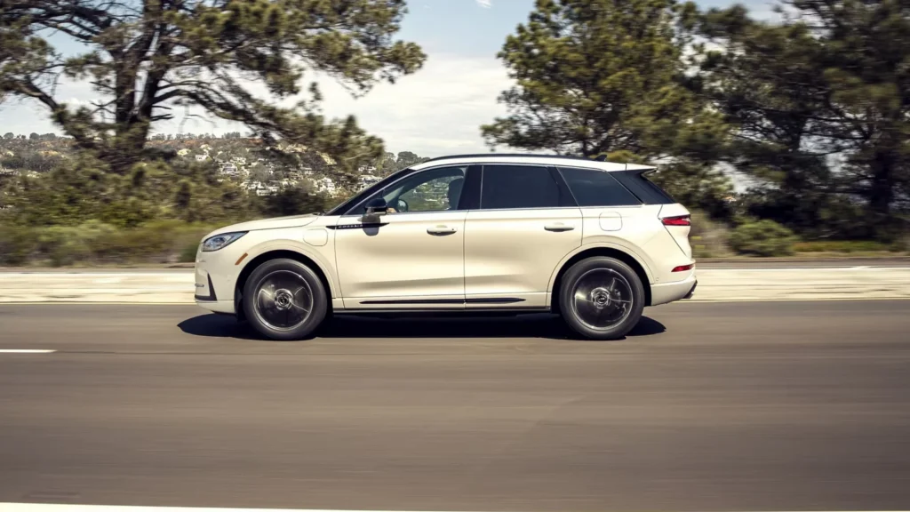 2025 Corsair Grand Touring in beige driving side profile with sleek roofline and black trim.