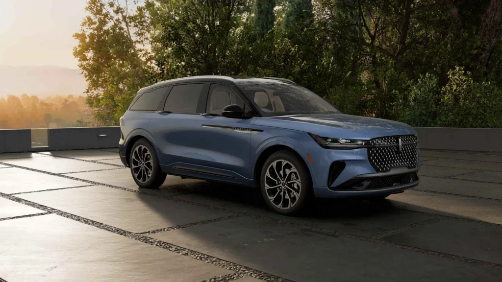 2026 Nautilus SUV in blue parked on stone driveway with modern headlights and sleek lines.