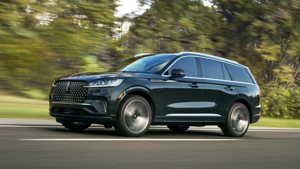 2025 Black Label Aviator® in dark finish driving with luxury grille and sculpted body lines.