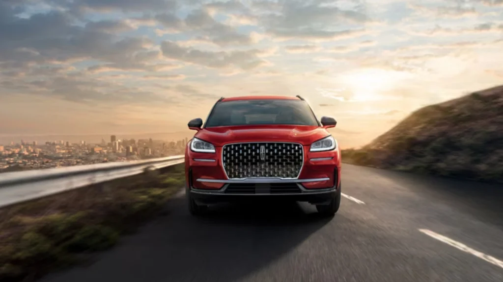 2025 Corsair® Grand Touring in red on coastal road highlighting signature Lincoln grille.