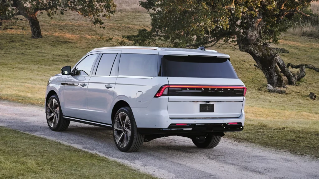 2025 Navigator® Reserve rear view parked on trail with LED tailbar and chrome accents.
