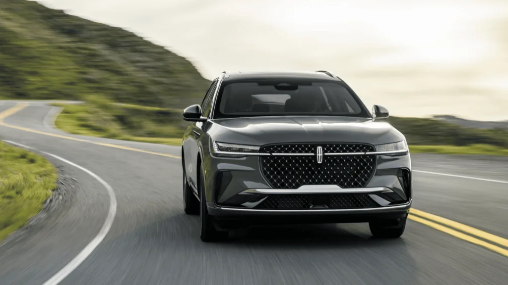 2026 Lincoln Nautilus® front exterior driving view with modern grille and luxury midsize SUV styling.