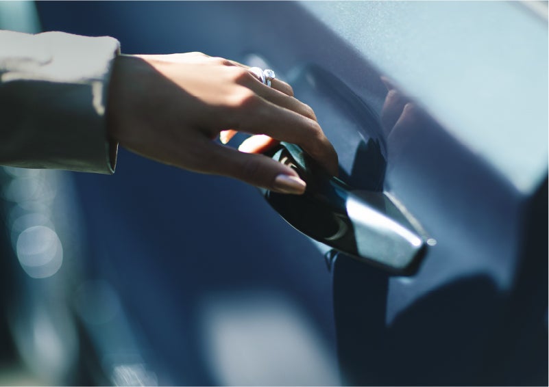 A hand gracefully grips the Light Touch Handle of a 2023 Lincoln Aviator® SUV to demonstrate its ease of use | Nick Mayer Lincoln Westlake in Westlake OH