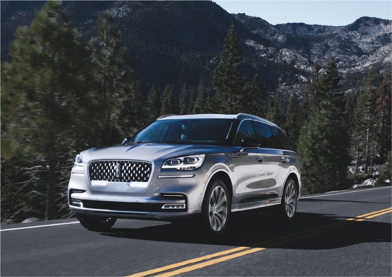 A 2023 Lincoln Aviator® Grand Touring SUV being driven on a winding road to demonstrate the capabilities of all-wheel drive | Nick Mayer Lincoln Westlake in Westlake OH