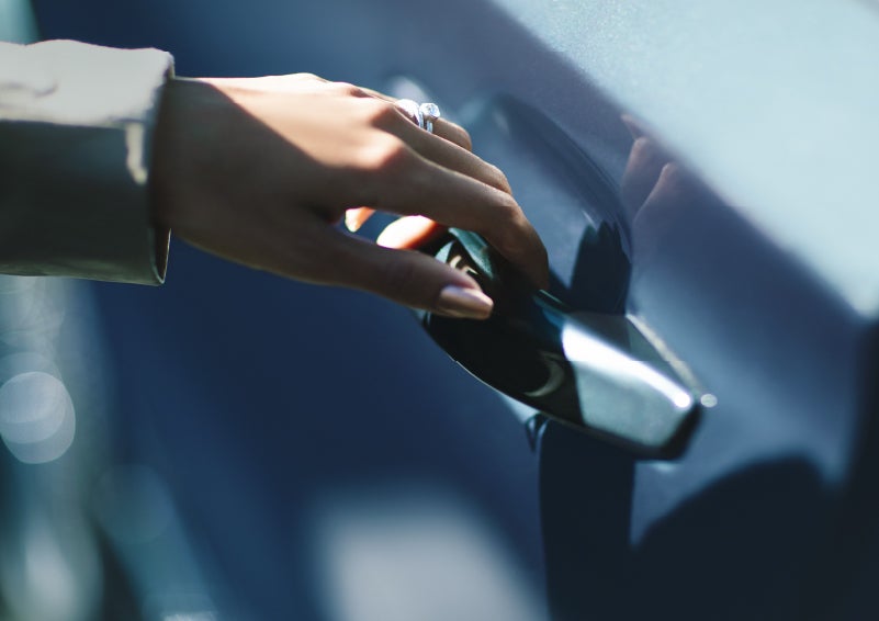 A hand gracefully grips the Light Touch Handle of a 2024 Lincoln Aviator® SUV to demonstrate its ease of use | Nick Mayer Lincoln Westlake in Westlake OH