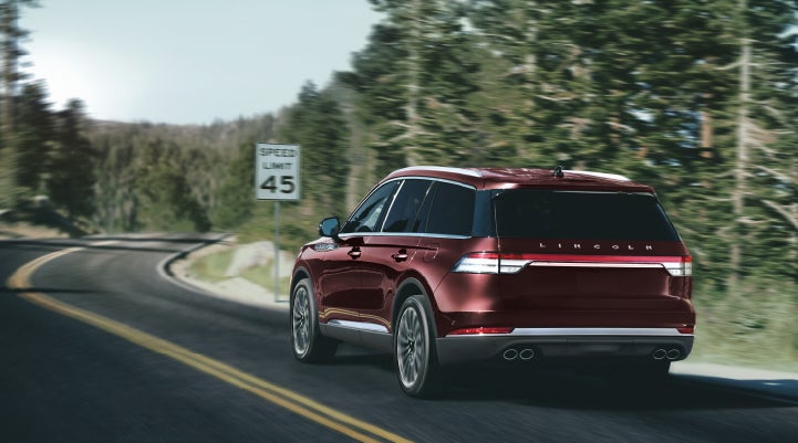 A 2024 Lincoln Aviator® SUV is being driven on a winding mountain road | Nick Mayer Lincoln Westlake in Westlake OH