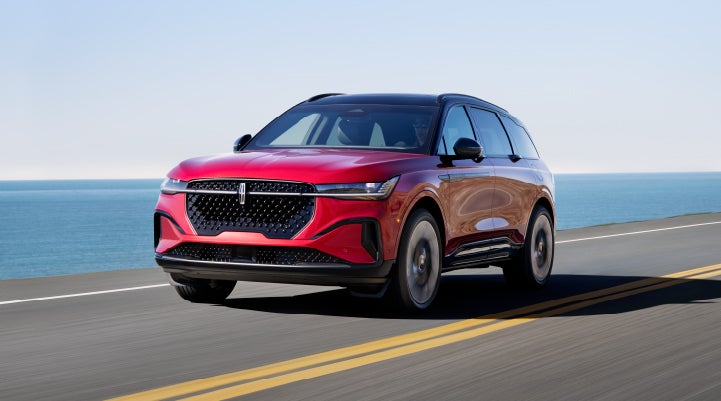 A 2024 Lincoln Nautilus® SUV is being driven on a seaside roadway. | Nick Mayer Lincoln Westlake in Westlake OH