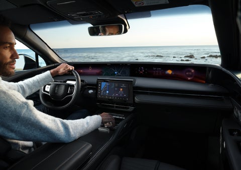 A driver of a parked 2024 Lincoln Nautilus® SUV takes a relaxing moment at a seaside overlook while inside his Nautilus. | Nick Mayer Lincoln Westlake in Westlake OH