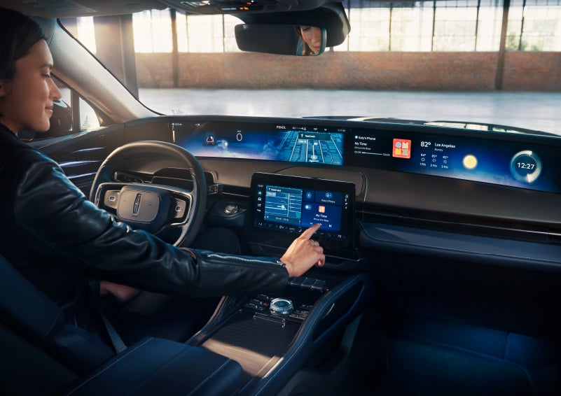 The driver of a 2024 Lincoln Nautilus® SUV interacts with the center touchscreen. | Nick Mayer Lincoln Westlake in Westlake OH