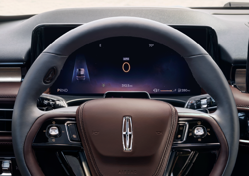 The steering wheel of 2025 Lincoln Aviator® SUV is shown with black and brown accents. | Nick Mayer Lincoln Westlake in Westlake OH
