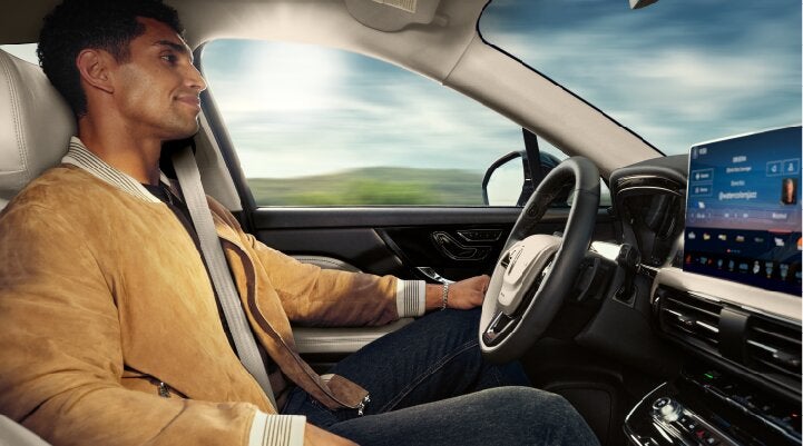 A person is shown using Lincoln BlueCruise hands-free highway driving technology on a divided highway called a Hands-Free Blue Zone. | Nick Mayer Lincoln Westlake in Westlake OH
