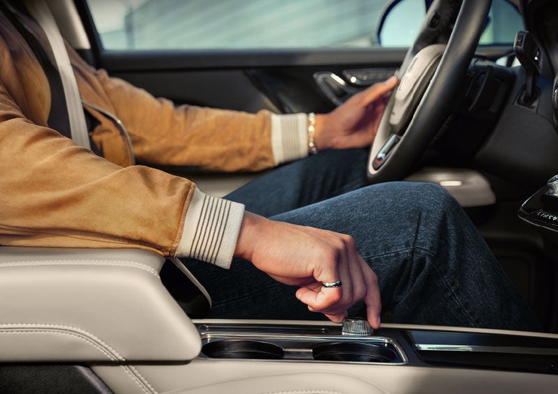 The driver of a 2024 Lincoln Corsair® SUV is shown selecting the drive mode. | Nick Mayer Lincoln Westlake in Westlake OH