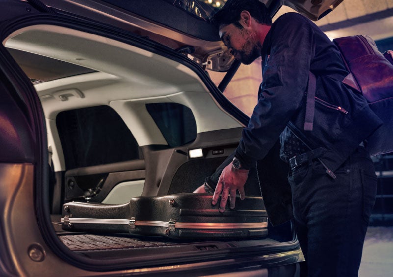 A man is shown loading cargo into the rear of a 2024 Lincoln Corsair® SUV with the second-row seats folded flat. | Nick Mayer Lincoln Westlake in Westlake OH