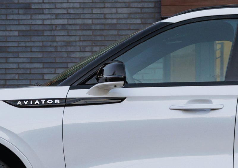 The driver’s side door and fender badging of a white 2026 Lincoln Aviator® SUV are showcased. | Nick Mayer Lincoln Westlake in Westlake OH