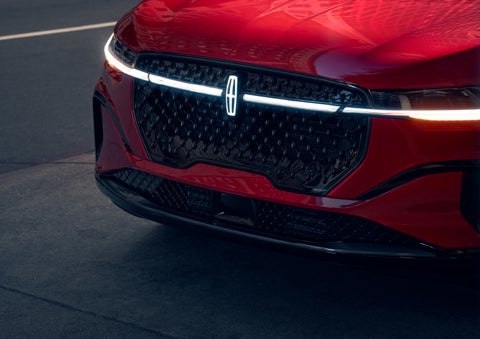 The available front LED light bar and center Lincoln Star logo glow at dusk. | Nick Mayer Lincoln Westlake in Westlake OH