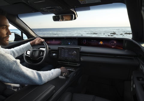 A driver of a parked 2026 Lincoln Nautilus® SUV takes a relaxing moment at a seaside overlook while inside his Nautilus. | Nick Mayer Lincoln Westlake in Westlake OH