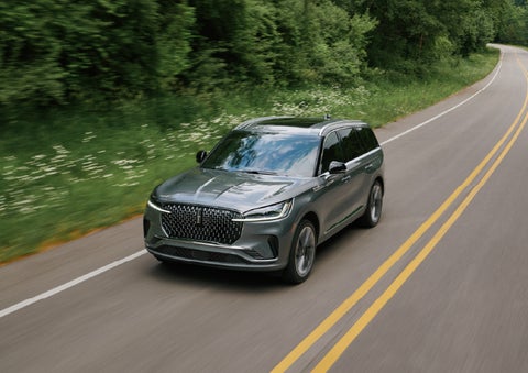 A 2027 Lincoln Aviator® SUV is being driven down a road. | Nick Mayer Lincoln Westlake in Westlake OH