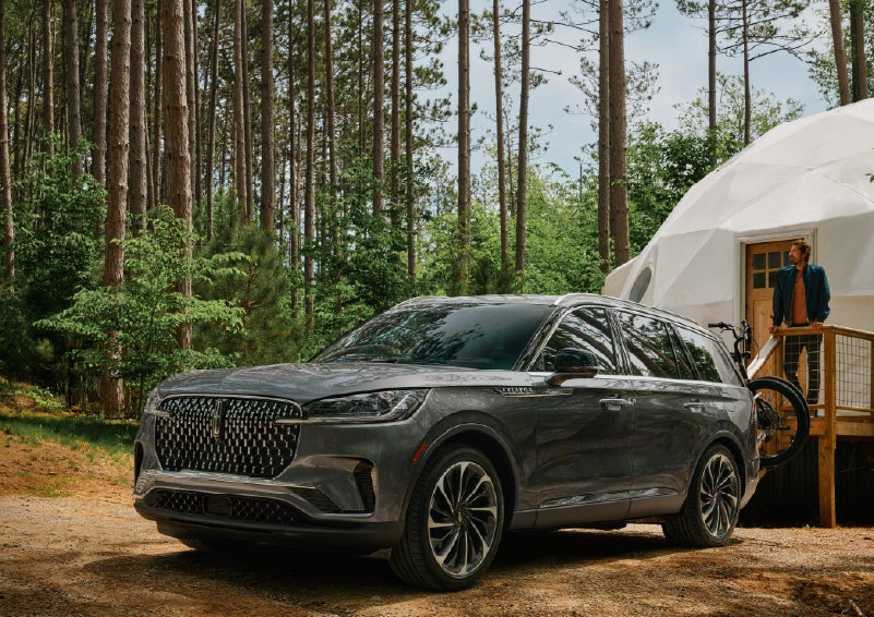 A 2027 Lincoln Aviator® is parked next to a high end glamping site. | Nick Mayer Lincoln Westlake in Westlake OH
