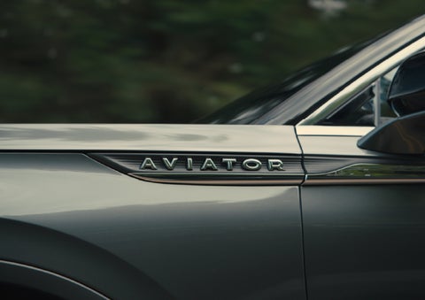 The driver’s side door and fender badging of a gray 2027 Lincoln Aviator® SUV are showcased. | Nick Mayer Lincoln Westlake in Westlake OH