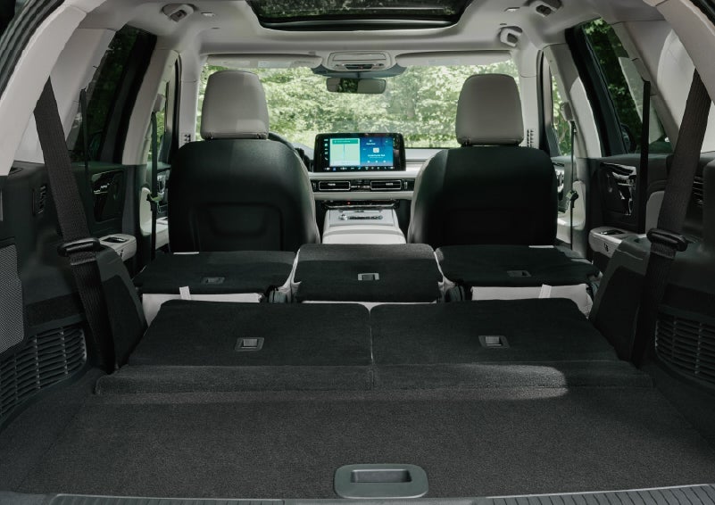 A rear to front view of the interior of a 2027 Lincoln Aviator® Black Label™ SUV shows the third and second rows folded flat | Nick Mayer Lincoln Westlake in Westlake OH
