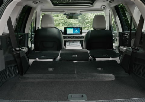 A rear to front view of the interior of a 2027 Lincoln Aviator® Black Label™ SUV shows the third and second rows folded flat | Nick Mayer Lincoln Westlake in Westlake OH