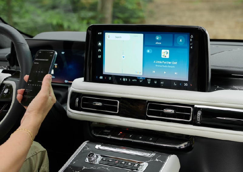 A person pairs thier phone with the center touchscreen of a 2027 Lincoln Aviator® Black Label™ SUV | Nick Mayer Lincoln Westlake in Westlake OH
