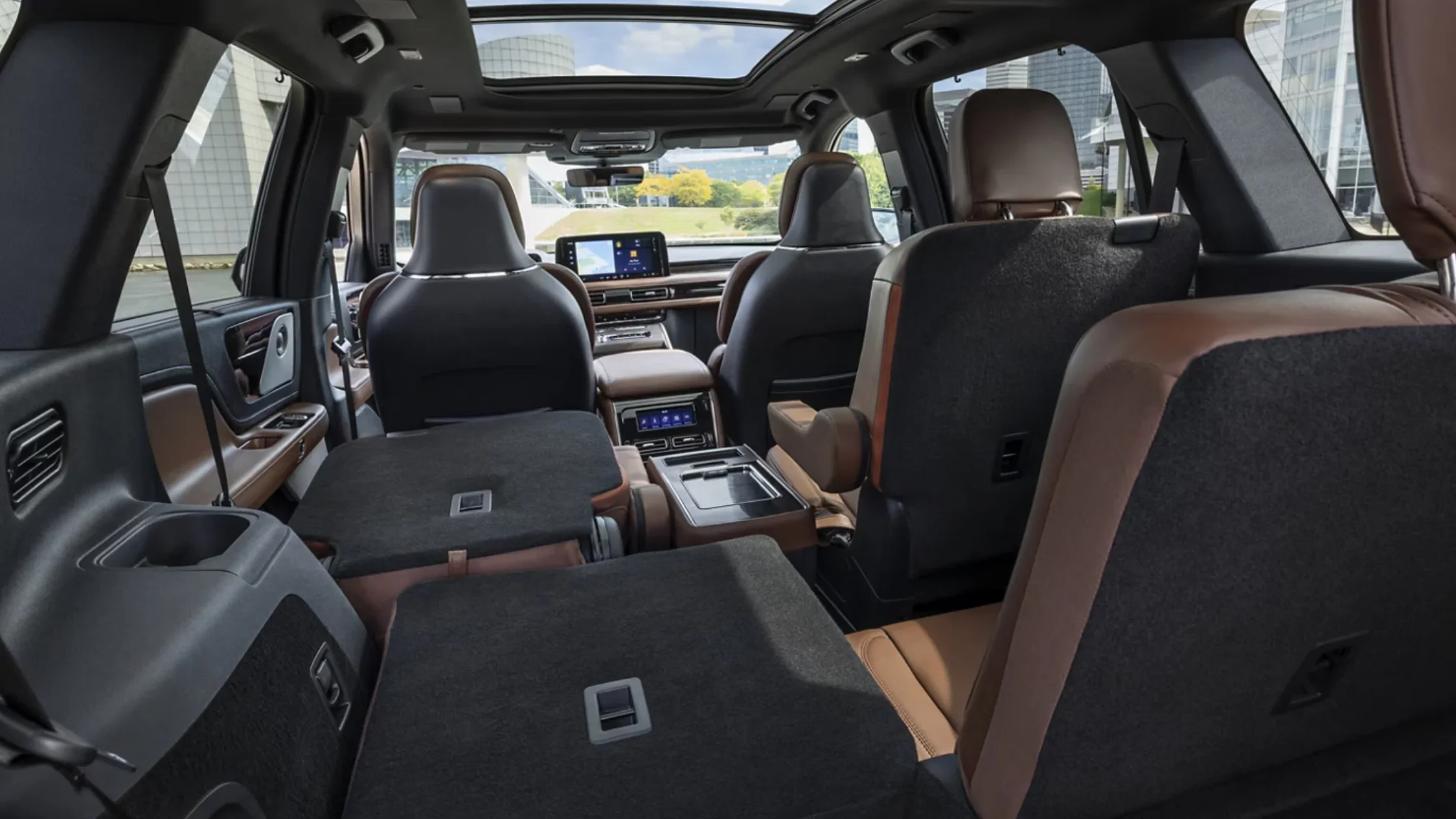 2025 Aviator® Reserve interior view with rear seats folded flat, panoramic roof, and spacious cargo area.