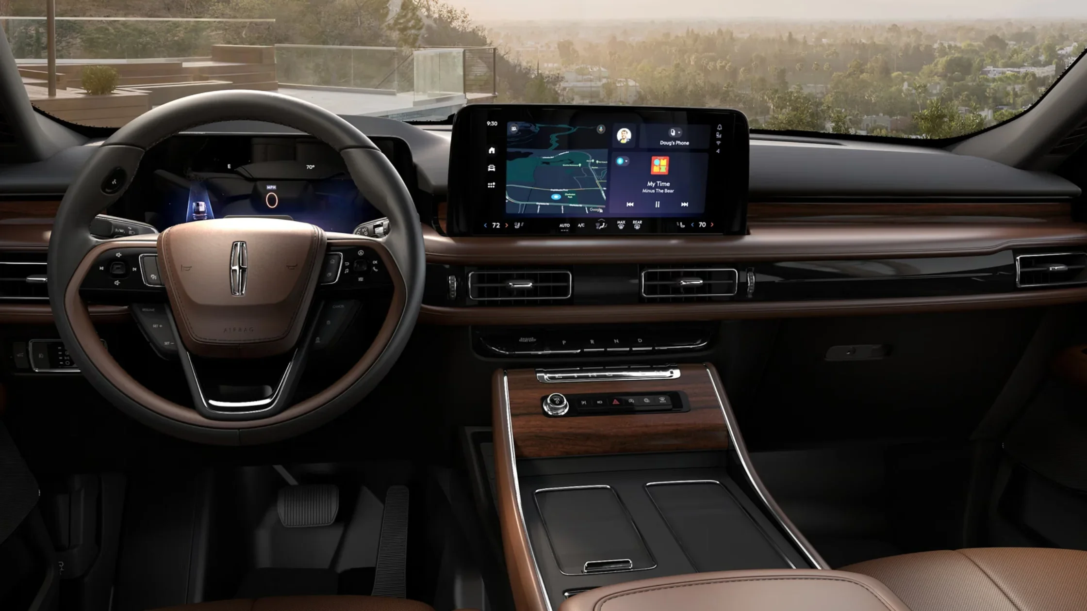 Interior of the 2025 Lincoln Aviator® Reserve in two-tone brown and black, with a touchscreen infotainment system, digital cluster, and leather-wrapped steering wheel.
