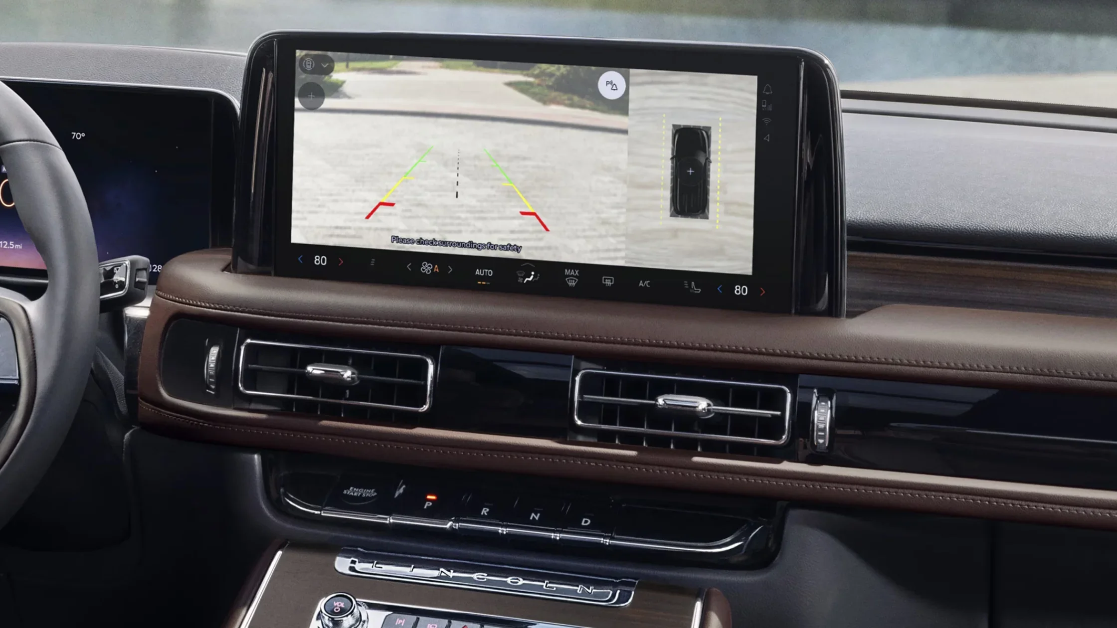 Close-up of the infotainment screen in the 2025 Lincoln Black Label Aviator® showing a rear-view camera interface with parking assist visuals.