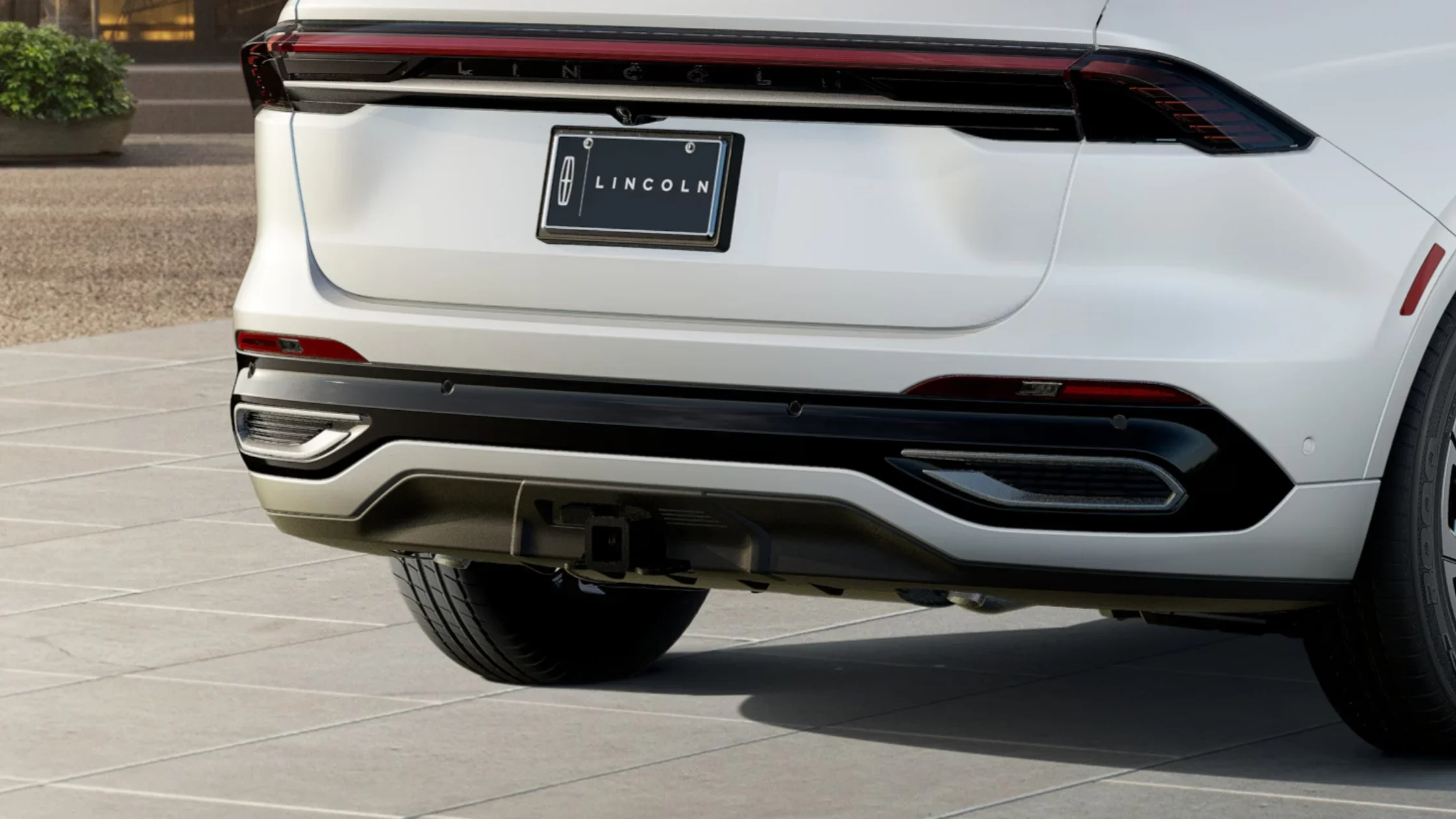 Rear close-up of the 2025 Lincoln Black Label Nautilus®, highlighting the Lincoln emblem, sleek taillights, and dual exhaust accents.