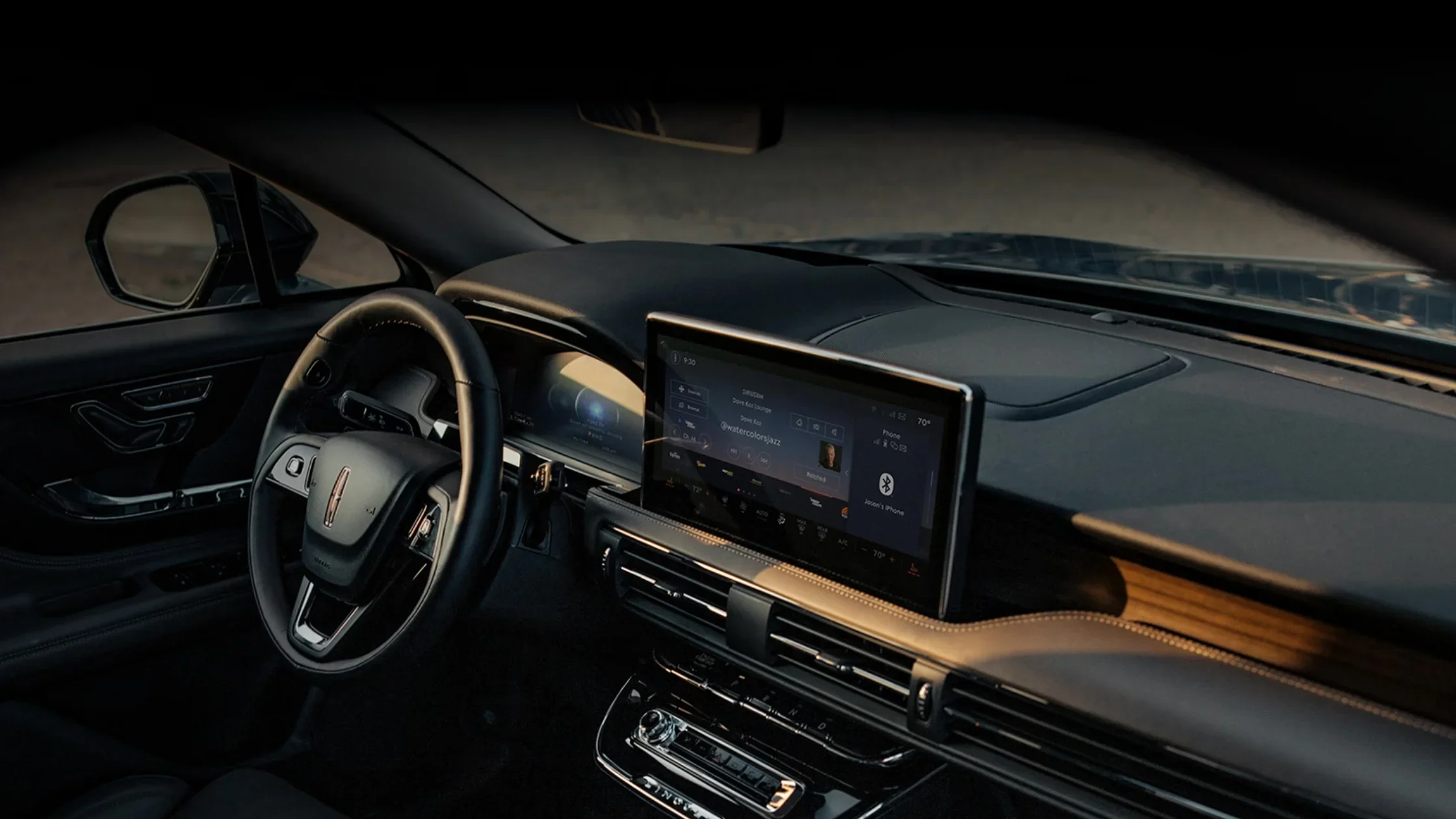 Interior of 2025 Lincoln Corsair Grand Touring with large central display, wood trim, and ambient lighting.