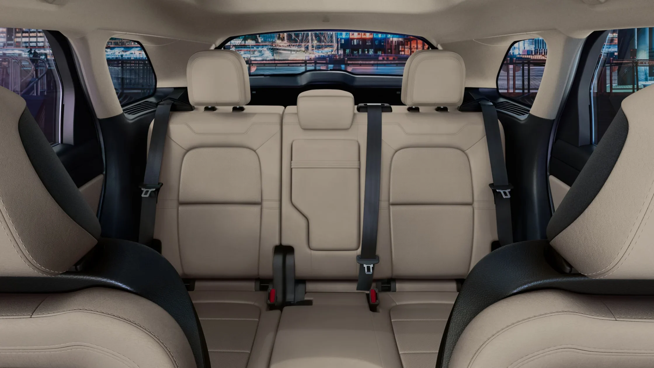 2025 Corsair® Reserve rear seating with beige leather upholstery, foldable seats, and city view through windows.