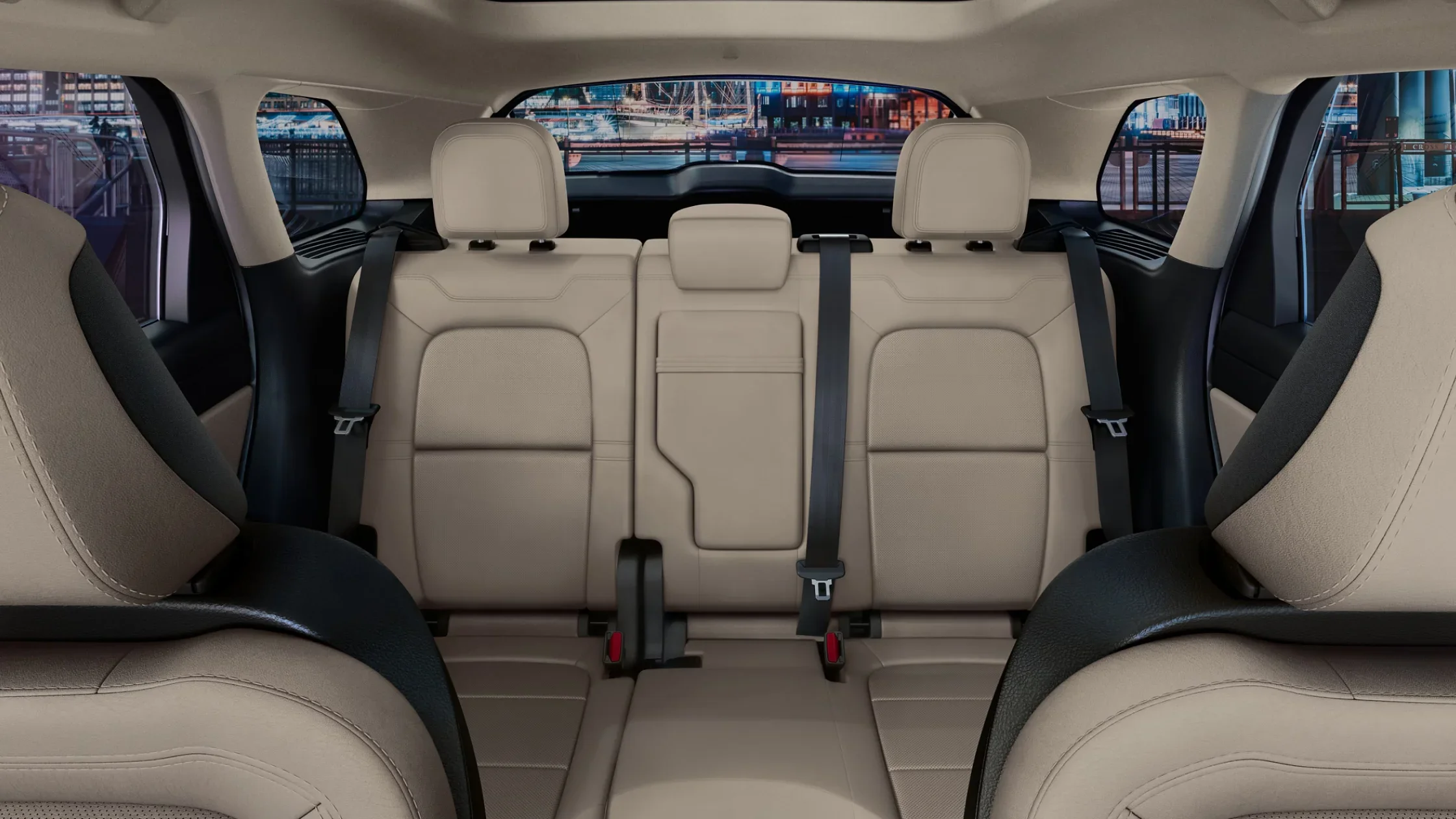 Rear seating view of the 2025 Lincoln Corsair® Reserve showing the beige leather-trimmed seats, headrests, and cityscape visible through the rear window.
