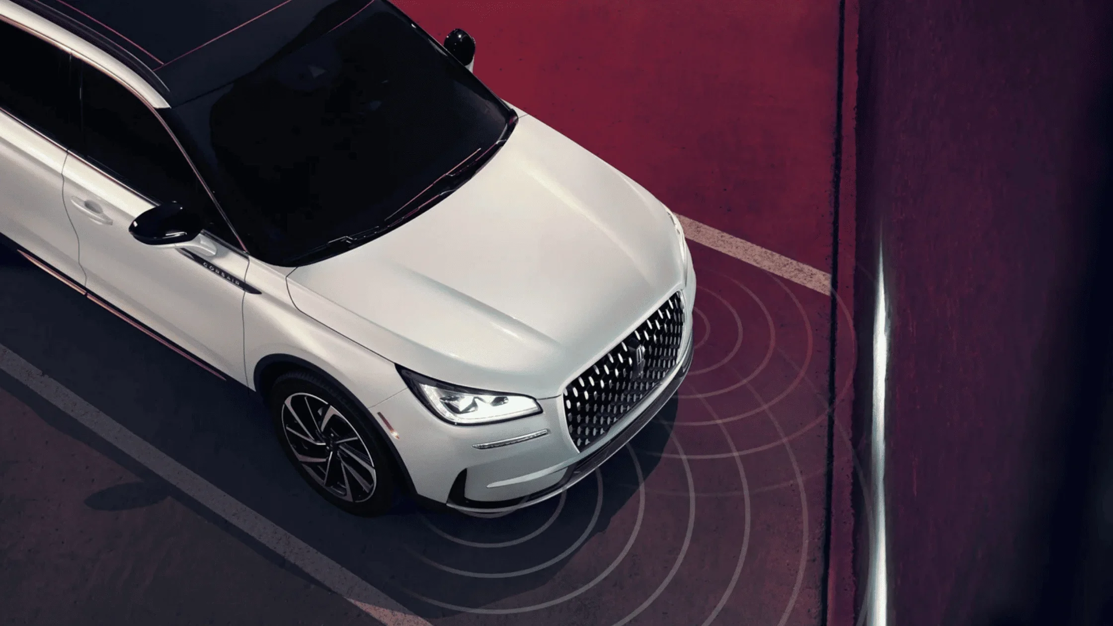 Overhead shot of 2025 Lincoln Corsair® showing active parking sensors in a tight urban space