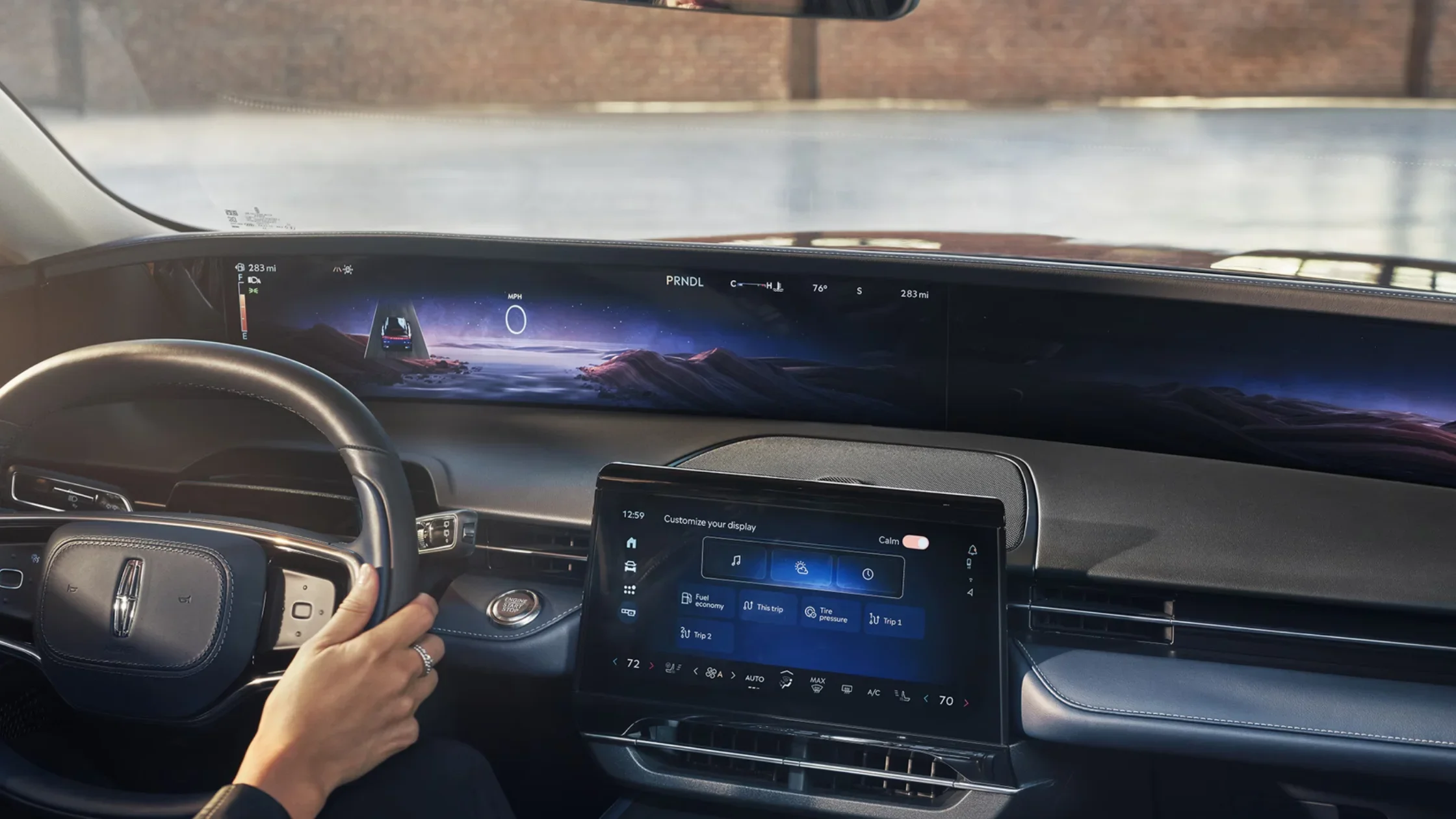 Interior cockpit of the 2025 Lincoln Nautilus® Reserve, highlighting the wide panoramic digital display, central touchscreen, and luxury steering wheel.