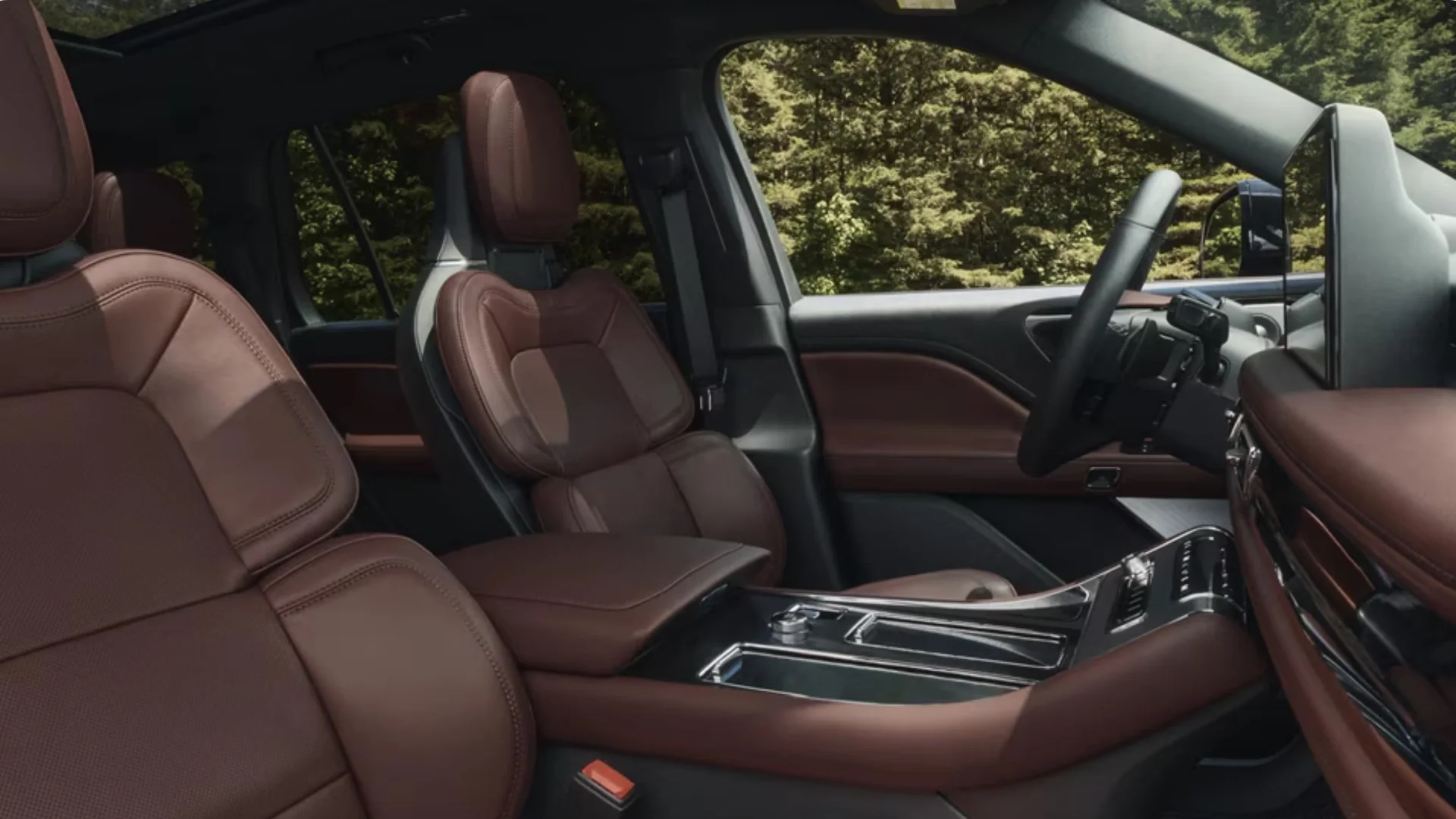Front cabin view of a 2025 Aviator® Reserve featuring premium brown leather seats and an upscale center console layout.