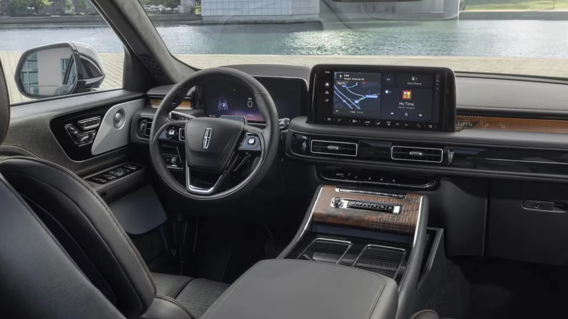 Driver-focused cockpit of the 2025 Black Label Aviator® featuring its digital display, leather-wrapped steering wheel, and wood-accented center console.