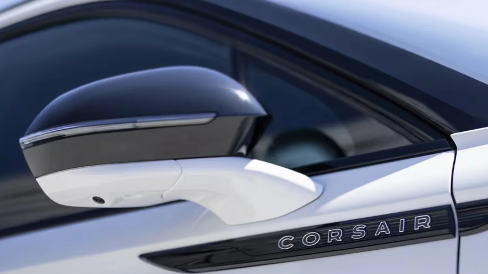 Close-up of the 2025 Corsair® Reserve side mirror showcasing its black-and-white finish and CORSAIR badging.