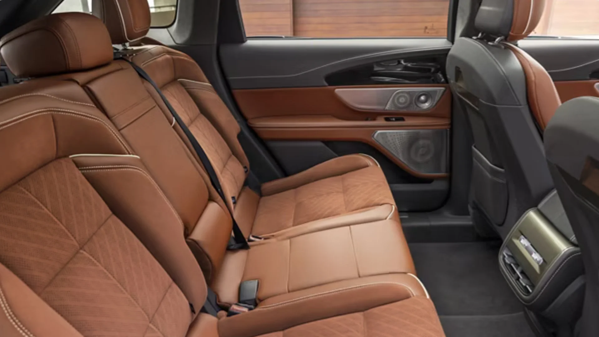 Rear seat view of the 2026 Nautilus® showcasing premium brown leather upholstery and detailed stitching.