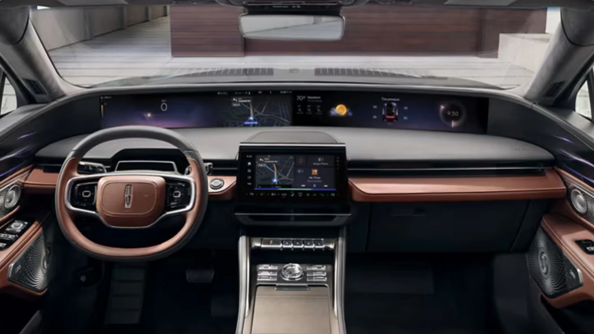 Driver-focused cabin of the 2026 Nautilus® with a widescreen display and leather-trimmed steering wheel.