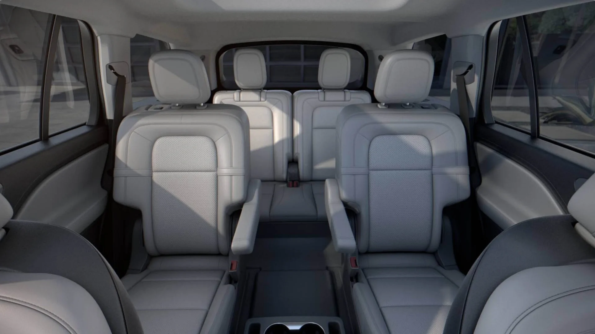 Interior rear cabin of the 2025 Lincoln Black Label Aviator® showcasing three rows of gray leather seats with a spacious, premium layout.