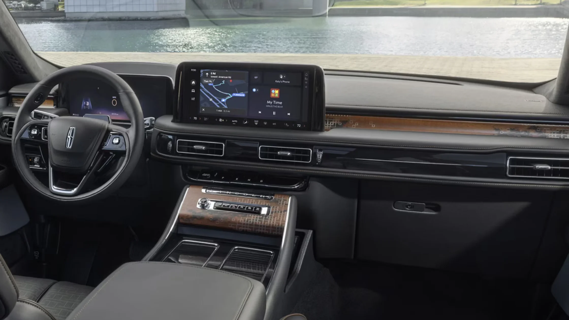 2025 Black Label Aviator® front seats and dashboard with black leather trim, wood accents, and touchscreen.