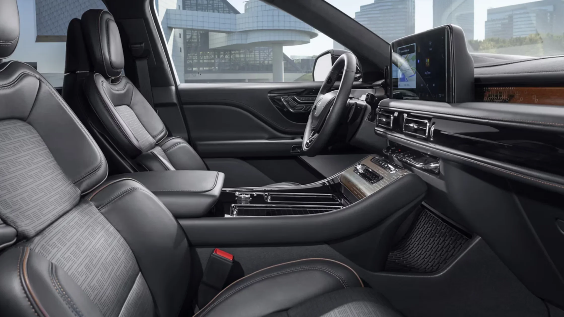 2025 Black Label Aviator® interior cockpit with leather steering wheel, digital display, and wood-trimmed console.